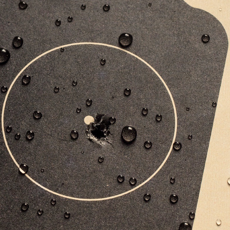 shooting target in black and off white with bullet holes
